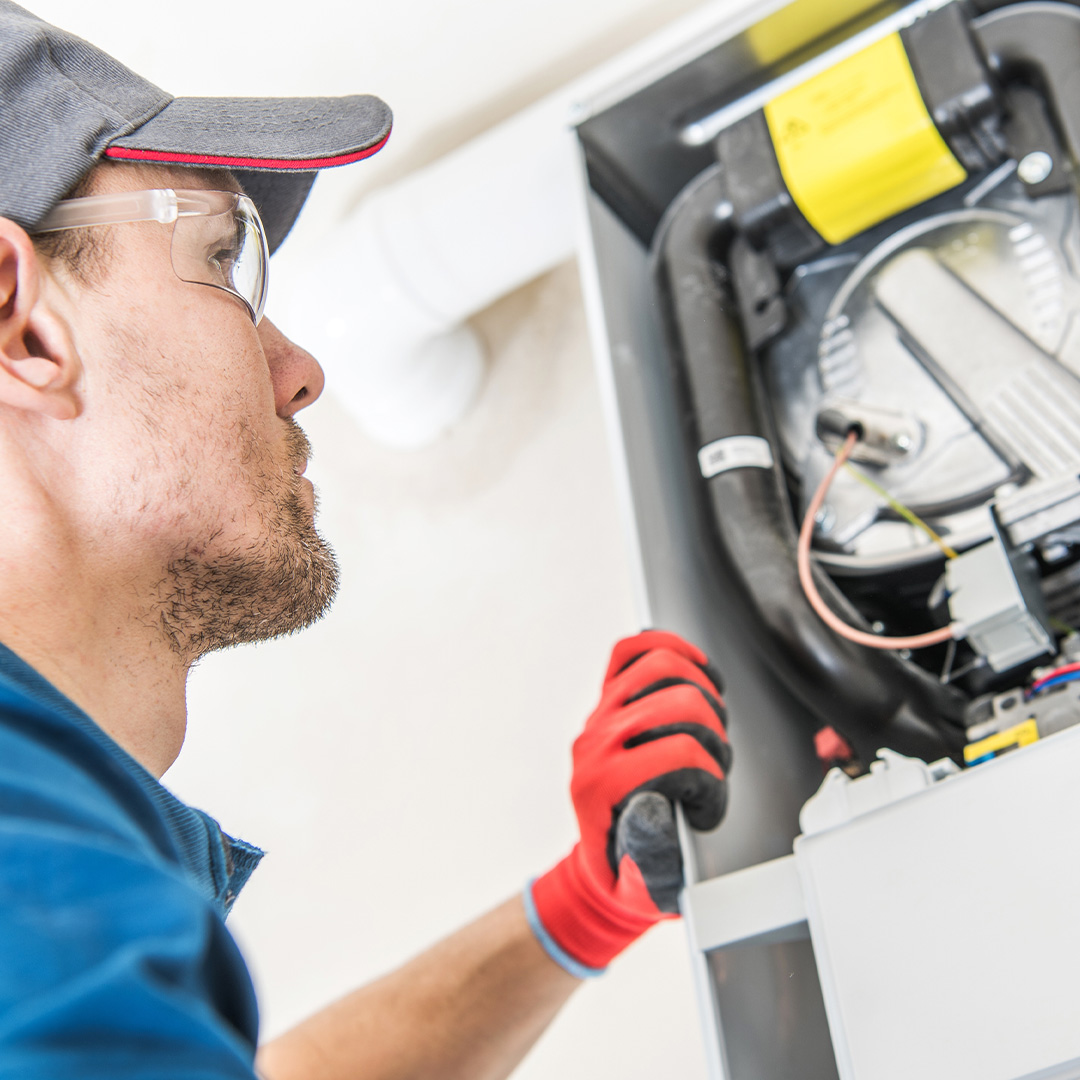 technician repairing furnance